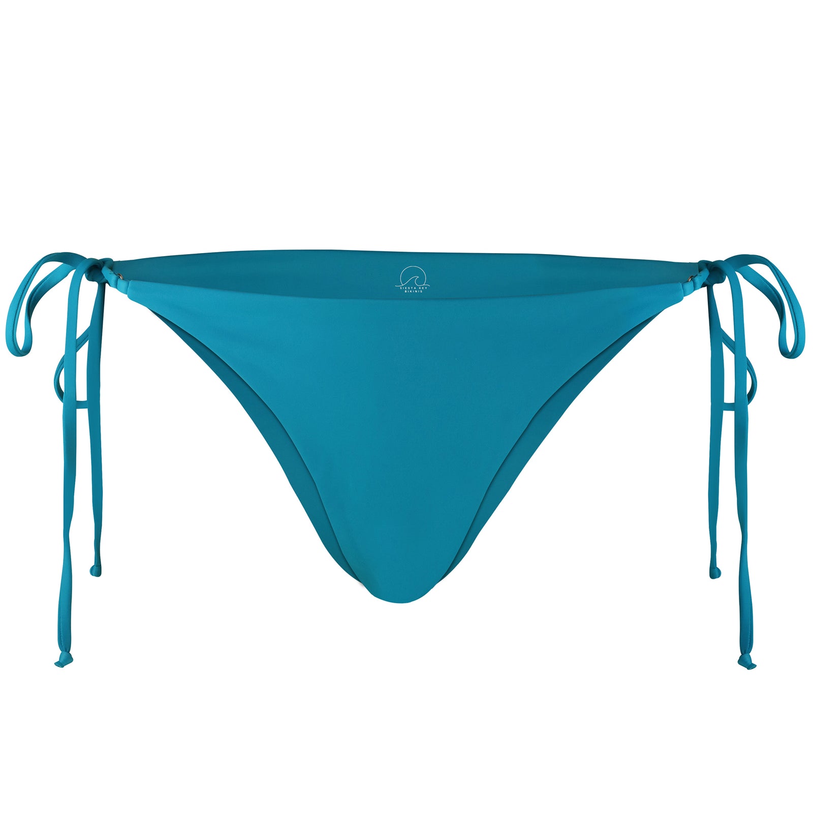 Siesta Key Bikini Babe standing in front of a brick wall wearing our Blue Siesta Key Bikini set. Classic bikini with ties on the sides